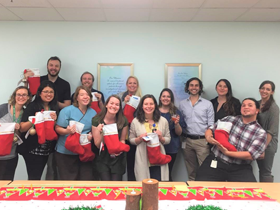 Team Members holding up stockings