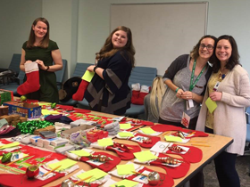 A table full of stocking supplies and happy team members