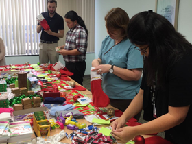 Team members stuffing stockings